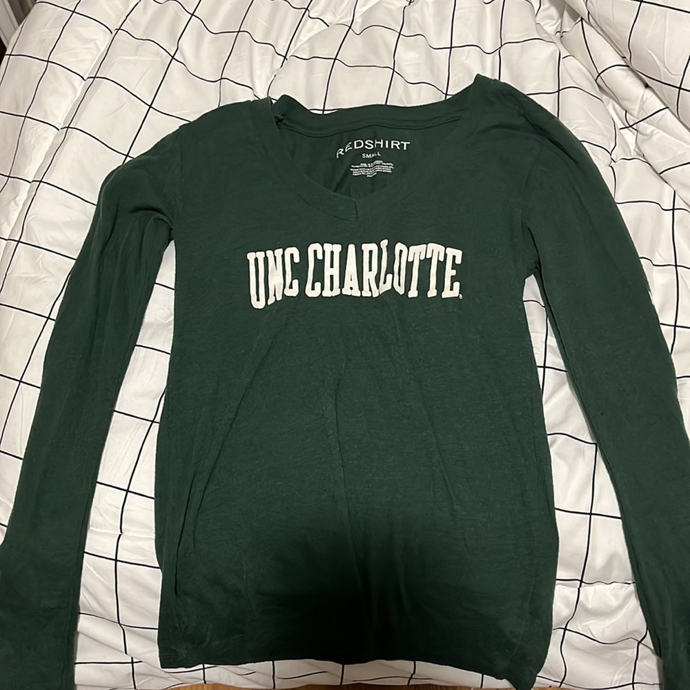 a green tight fitting, long sleeve that is slightly worn